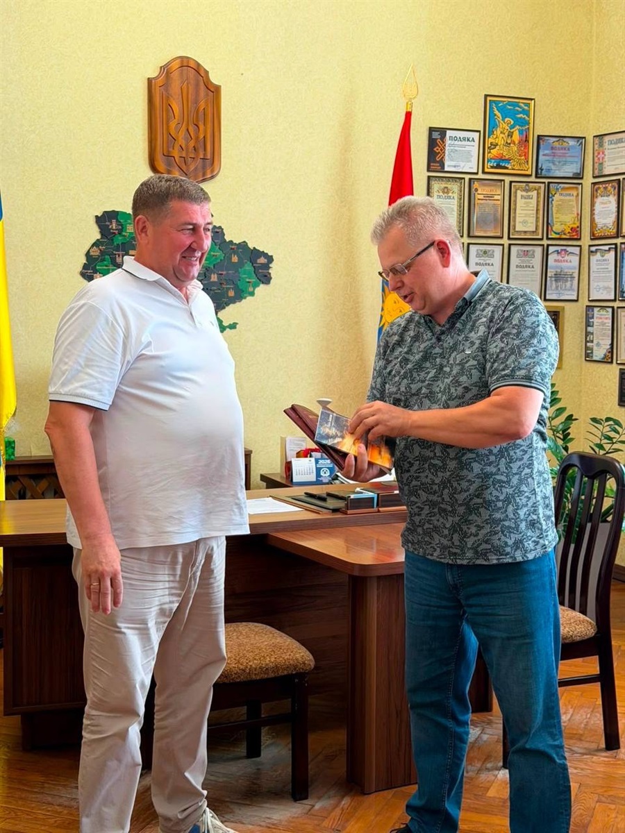 Віктор Терещенко вручає Володимиру Василишену книги великобурлуцьких авторів — Клавдії Оковитої та Раїси Баштан.